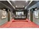 Home theater with tiered seating, projector, large movie posters and sconce lighting, offering an immersive experience at 150 Stone Pond Ln, Johns Creek, GA 30022