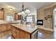 Stylish kitchen with center island, fireplace, and adjacent eating area at 150 Stone Pond Ln, Johns Creek, GA 30022