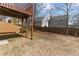 View of the backyard, wooden deck, and trees from under the deck at 4263 Winslow Hill Ct, Suwanee, GA 30024