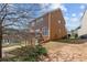 Landscaped backyard with mature trees and view of the home's exterior at 4263 Winslow Hill Ct, Suwanee, GA 30024