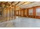 Unfinished basement with concrete floor, exposed framing, and insulation at 4263 Winslow Hill Ct, Suwanee, GA 30024