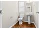 Bathroom with pedestal sink, wood-look floor, and large window at 4263 Winslow Hill Ct, Suwanee, GA 30024