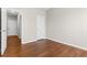 Bedroom with neutral walls and wood-look flooring with an open doorway to hallway at 4263 Winslow Hill Ct, Suwanee, GA 30024