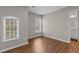 Empty bedroom with fresh paint, wood-look flooring, and an open doorway at 4263 Winslow Hill Ct, Suwanee, GA 30024