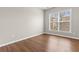 Bedroom featuring wood-look flooring and a bright window for natural light at 4263 Winslow Hill Ct, Suwanee, GA 30024