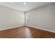 Empty bedroom featuring wood-look flooring, fresh paint, and a window at 4263 Winslow Hill Ct, Suwanee, GA 30024