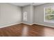 Bedroom with wood-look flooring, fresh paint, and large windows at 4263 Winslow Hill Ct, Suwanee, GA 30024