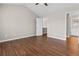 Large bedroom with vaulted ceilings, wood-look floors, and an open door to bathroom at 4263 Winslow Hill Ct, Suwanee, GA 30024