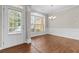 Elegant dining room featuring dark hardwood floors, neutral wall colors, decorative molding, and a large window at 4263 Winslow Hill Ct, Suwanee, GA 30024