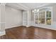 Elegant dining room featuring dark hardwood floors, neutral wall colors, decorative molding, and a large window at 4263 Winslow Hill Ct, Suwanee, GA 30024