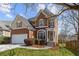 Charming two-story home featuring a brick facade, attached garage, and manicured lawn at 4263 Winslow Hill Ct, Suwanee, GA 30024