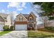 Charming two-story home featuring a brick facade, manicured lawn, attached garage, and inviting curb appeal at 4263 Winslow Hill Ct, Suwanee, GA 30024