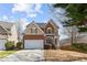 Charming two-story home featuring a brick and siding facade with a well-maintained front yard and attached garage at 4263 Winslow Hill Ct, Suwanee, GA 30024