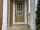 Close up of a front door flanked by white columns and offering secure entry into the residence at 4263 Winslow Hill Ct, Suwanee, GA 30024