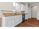 Kitchen features white cabinets, granite countertops and stainless steel appliances at 4263 Winslow Hill Ct, Suwanee, GA 30024