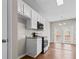 Kitchen boasts white cabinets, stainless appliances, granite countertops, and deck access for indoor/outdoor flow at 4263 Winslow Hill Ct, Suwanee, GA 30024