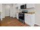 Kitchen with granite countertops, stainless steel oven and microwave, and white cabinets at 4263 Winslow Hill Ct, Suwanee, GA 30024