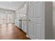 Kitchen with white cabinets and stainless steel dishwasher, opening onto a bright living space with deck access at 4263 Winslow Hill Ct, Suwanee, GA 30024