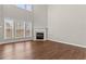 Bright living room with hardwood floors, a fireplace, and large windows offering lots of natural light at 4263 Winslow Hill Ct, Suwanee, GA 30024