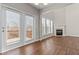 Spacious living room with high ceilings, a fireplace, and sliding glass doors to the outdoor space at 4263 Winslow Hill Ct, Suwanee, GA 30024