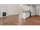 Open floor plan showing living room with fireplace and kitchen with granite countertops and stainless appliances at 4263 Winslow Hill Ct, Suwanee, GA 30024