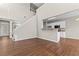 Open-concept living area featuring hardwood floors, access to a kitchen, and an entry doorway at 4263 Winslow Hill Ct, Suwanee, GA 30024