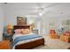 Cozy bedroom featuring a ceiling fan, wood bed frame, and two floral chairs at 4470 Crestwicke Pointe, Atlanta, GA 30319