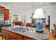 Kitchen island with gas cooktop and view of the living area at 4470 Crestwicke Pointe, Atlanta, GA 30319