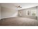 Large carpeted living room featuring two windows and a glass patio door at 2285 Moondance Ln, Marietta, GA 30062