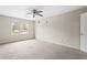Spacious bedroom with neutral walls and carpet, a ceiling fan, and a large window for natural light at 3775 Norman Rd, Clarkston, GA 30021