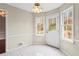 Bright dining area with white door, tile floors, large windows, and decorative light fixture at 3775 Norman Rd, Clarkston, GA 30021