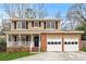 Charming two-story home with brick accents, front porch, and attached two car garage at 3775 Norman Rd, Clarkston, GA 30021
