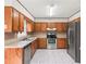 Functional kitchen with stainless steel appliances, laminate countertops, and wood cabinetry at 3775 Norman Rd, Clarkston, GA 30021
