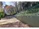 Concrete back patio featuring a dining set and a retaining wall with established plantings at 4234 Long Branch Ne Ct, Brookhaven, GA 30319