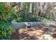 Serene backyard with a charming white bench seat and peaceful landscaping at 4234 Long Branch Ne Ct, Brookhaven, GA 30319