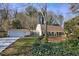 Attractive home with a long driveway, attached garage, and lovely landscaping at 4234 Long Branch Ne Ct, Brookhaven, GA 30319