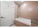 Bright bathroom with a granite countertop and showerhead over a deep soaking tub at 1080 Peachtree Ne St # 2207, Atlanta, GA 30309