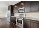 Elegant kitchen with stainless steel appliances, granite counter tops, and dark wood cabinets at 1080 Peachtree Ne St # 2207, Atlanta, GA 30309