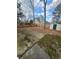 Spacious backyard with a storage shed, a fence, and large trees at 3118 Rockbridge Road Southwest, Avondale Estates, GA 30002