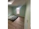 Cozy bedroom with wood-look floors, a window, and a fresh coat of paint at 3118 Rockbridge Road Southwest, Avondale Estates, GA 30002