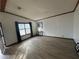 Bright living room featuring wood trim, a large window with curtains, and light-colored floors at 3118 Rockbridge Road Southwest, Avondale Estates, GA 30002