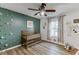 This charming Bedroom has a crib with a green accent wall and hardwood floors at 3852 Old Bridge Way, Duluth, GA 30096