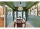 Elegant dining room featuring green walls, natural lighting, and a stylish chandelier at 3852 Old Bridge Way, Duluth, GA 30096