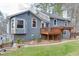 Exterior of home with landscaped yard, deck, and covered patio at 3852 Old Bridge Way, Duluth, GA 30096