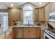 Kitchen with stainless steel appliances and a large window above the kitchen sink at 3852 Old Bridge Way, Duluth, GA 30096