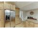 Kitchen with stainless steel refrigerator and adjacent access to the stairs at 3852 Old Bridge Way, Duluth, GA 30096