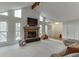 Bright living room featuring a stone fireplace, vaulted ceiling, and large windows at 3852 Old Bridge Way, Duluth, GA 30096