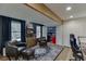 Cozy living room features a bar behind bi-fold doors, hardwood floors, and a wood beam at 3852 Old Bridge Way, Duluth, GA 30096