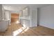 White kitchen featuring modern appliances and updated cabinets with a hardwood floor at 4103 Statewood Ne Rd, Atlanta, GA 30342