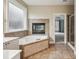 Bathroom features soaking tub, tiled floor, and a fireplace, offering a relaxing spa-like experience at 6445 Glen Oaks Ln, Sandy Springs, GA 30328